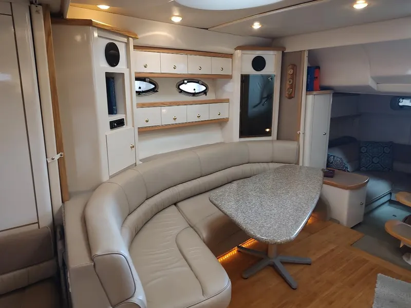 Slide: The Image of Luxurious interior of 1998 Maxum 4100 Sun Bridge SCR yacht with curved seating and modern decor. - 18