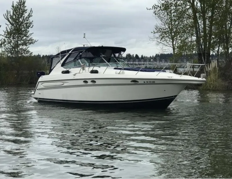 Slide: The Image of 1998 Maxum 4100 Sun Bridge SCR boat on calm water, surrounded by trees. - 2