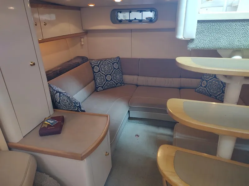 Slide: The Image of 1998 Maxum 4100 Sun Bridge SCR interior with beige seating and decorative pillows. - 20