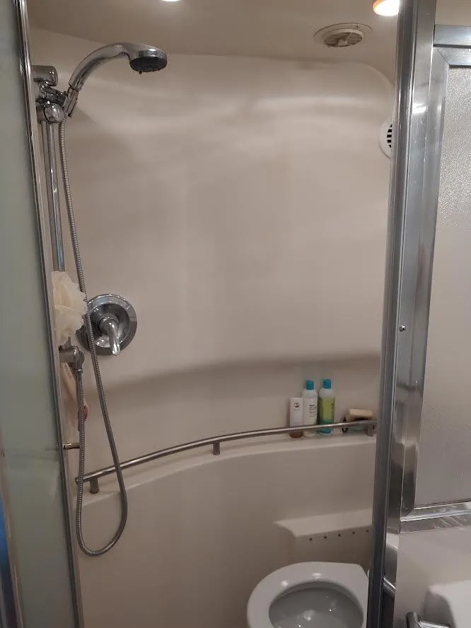 Slide: The Image of Bathroom interior of 1998 Maxum 4100 Sun Bridge SCR yacht, featuring shower and toilet. - 22