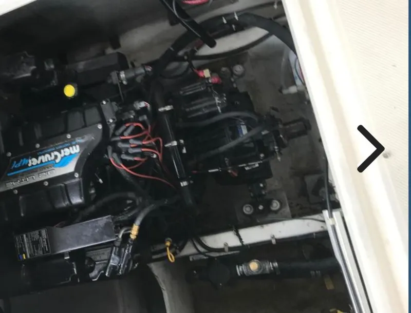 Slide: The Image of Engine compartment of a 1998 Maxum 4100 SUN BRIDGE SCR boat, featuring a MerCruiser engine. - 25