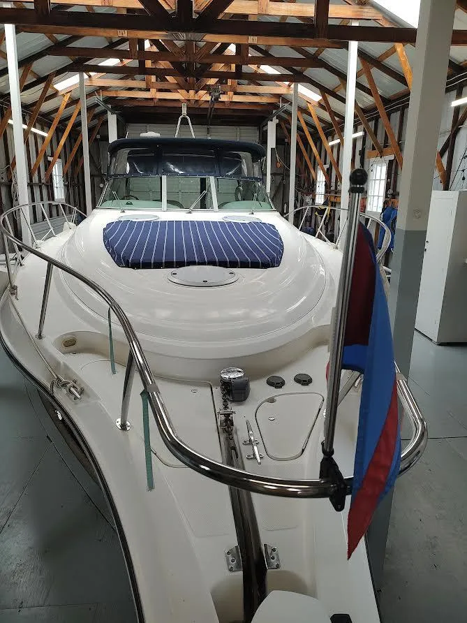 Slide: The Image of 1998 Maxum 4100 Sun Bridge SCR yacht in a boathouse, featuring sleek design and blue accents. - 3