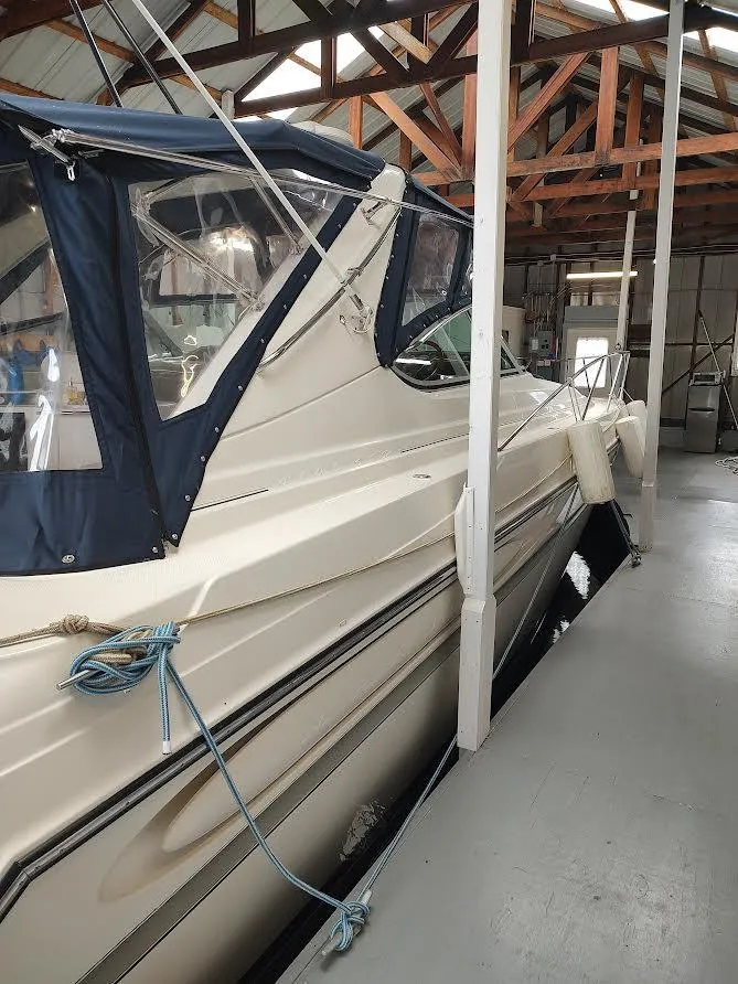Slide: The Image of 1998 Maxum 4100 Sun Bridge SCR yacht docked in a covered marina. - 4
