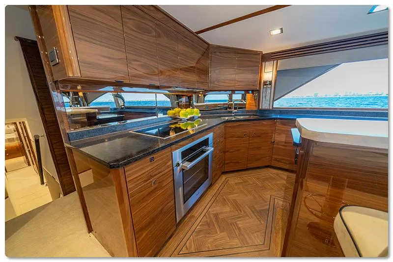 Slide: The Image of Luxurious kitchen interior of 2026 Viking 90 Skybridge yacht with modern appliances and wood finish. - 3
