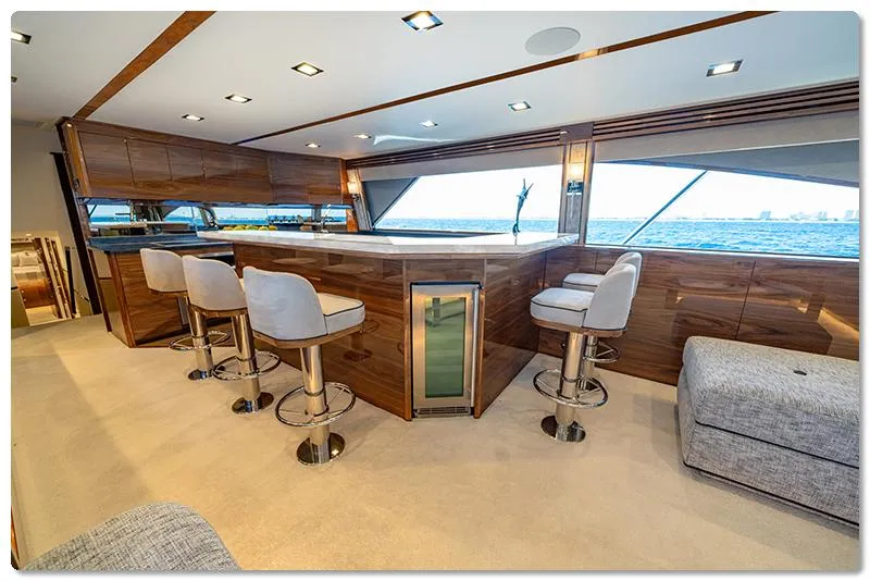 Slide: The Image of Luxurious interior of 2026 Viking 90 Skybridge yacht with modern bar and ocean view. - 4