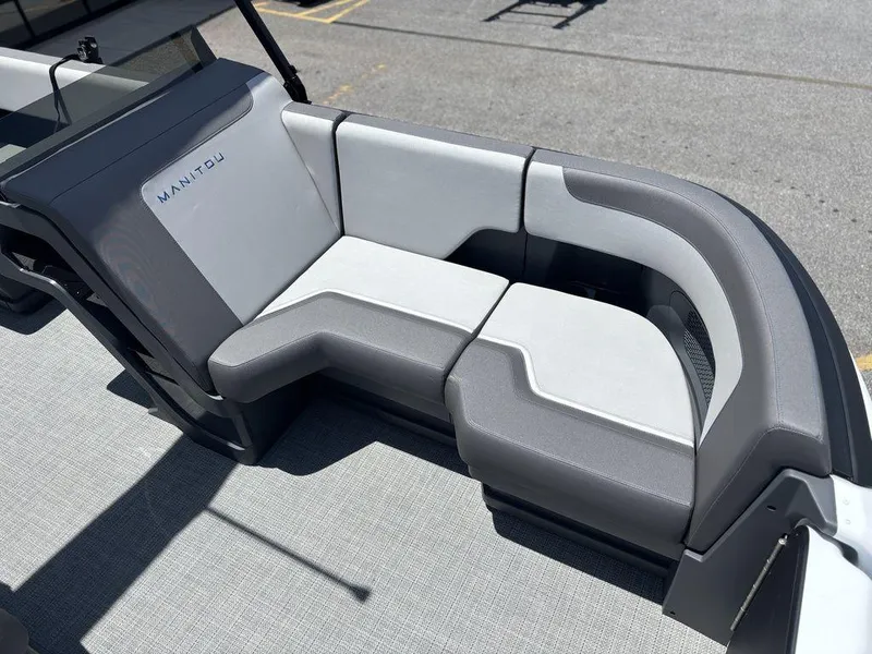 Slide: The Image of 2025 Manitou Cruise 22 Max Switchback boat seating, featuring modern gray and white upholstery. - 11