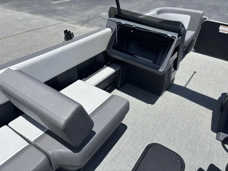 Slide: The Image of 2025 Manitou Cruise 22 Max Switchback interior with gray seating and storage compartment. - 14