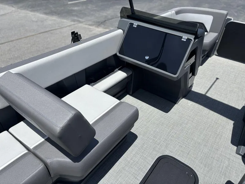 Slide: The Image of Interior of 2025 Manitou Cruise 22 Max Switchback boat with modern seating and console. - 17