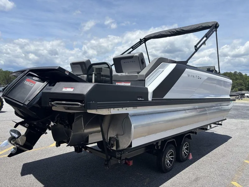 Slide: The Image of 2025 Manitou Cruise 22 Max Switchback pontoon boat on trailer, rear view. - 2