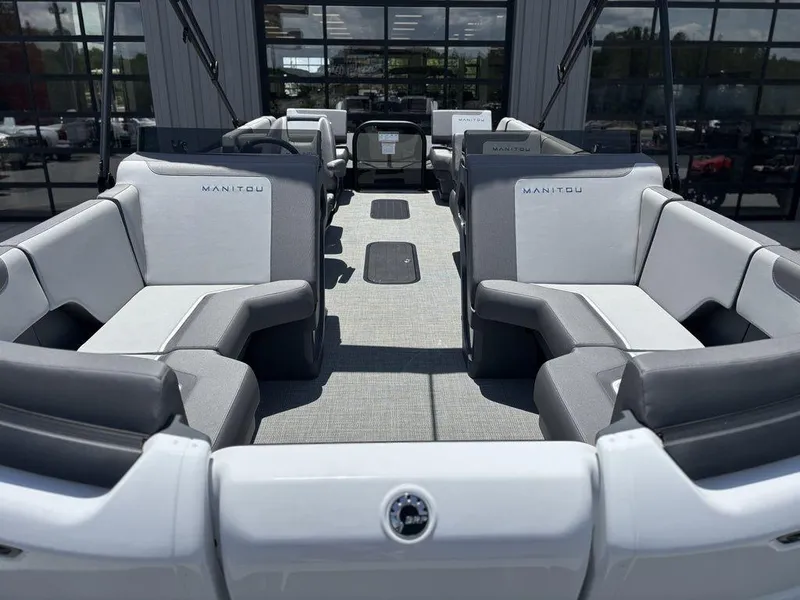 Slide: The Image of 2025 Manitou Cruise 22 Max Switchback pontoon boat interior with gray seating and modern design. - 8