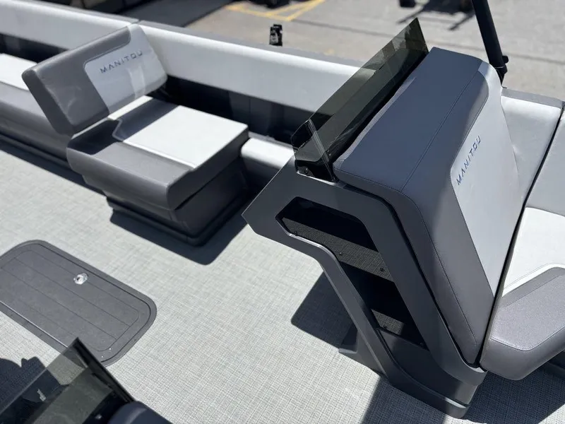 Slide: The Image of 2025 Manitou Cruise 22 Max Switchback boat interior with modern seating and sleek design. - 9