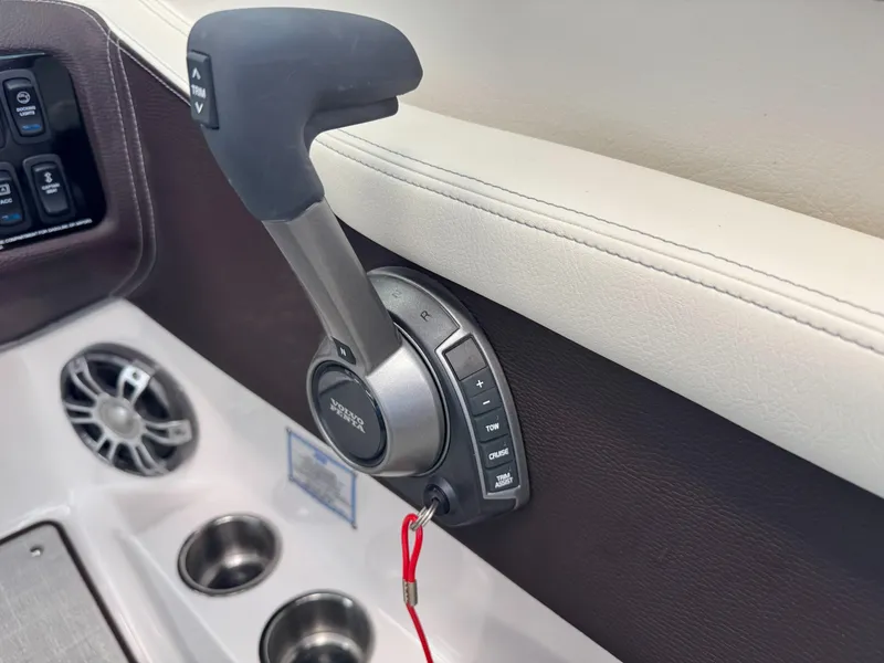 Slide: The Image of Throttle control of 2025 Regal LS6 boat with cup holders and speaker. - 11