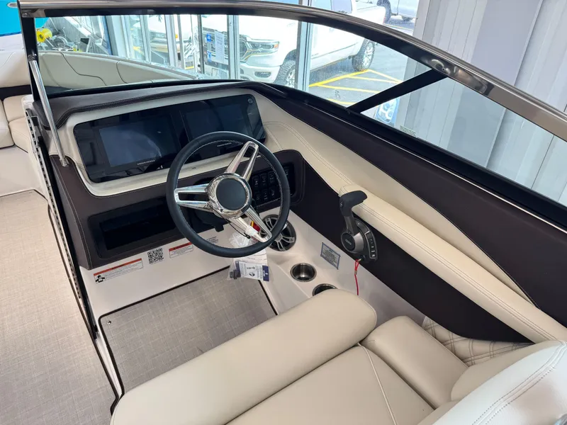 Slide: The Image of 2025 Regal LS6 boat interior with modern steering and dashboard controls. - 16
