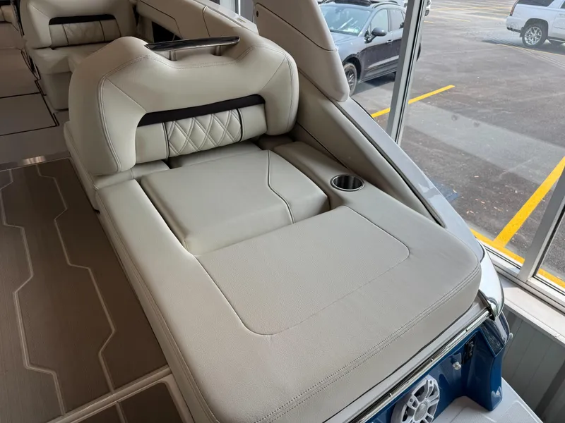 Slide: The Image of Luxurious interior of 2025 Regal LS6 boat with plush seating and cup holder. - 23