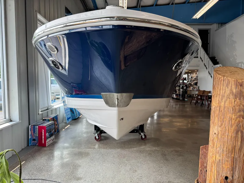 Slide: The Image of 2025 Regal LS6 boat displayed indoors, showcasing sleek blue and white hull design. - 27