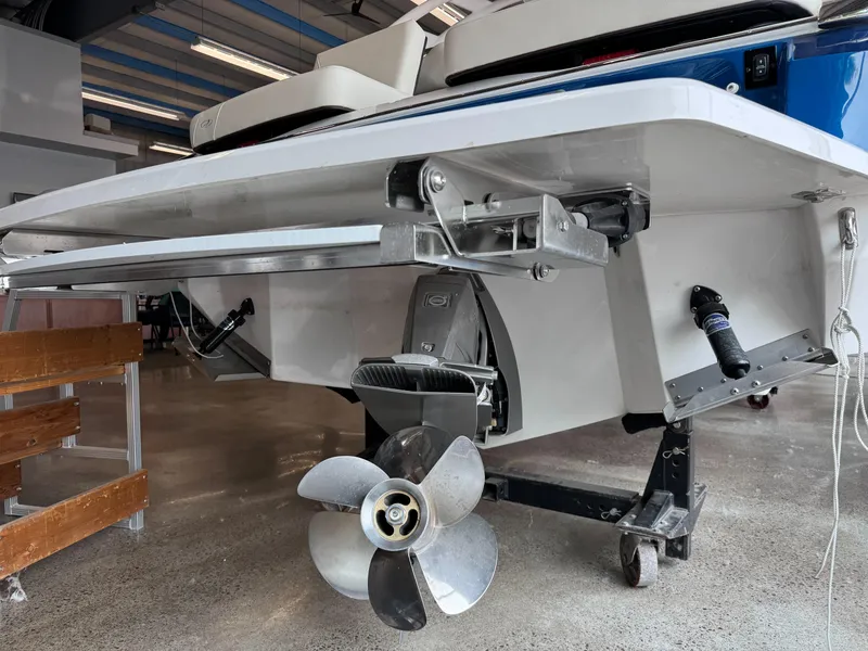 Slide: The Image of 2025 Regal LS6 boat stern with propeller and outboard motor in a showroom. - 3