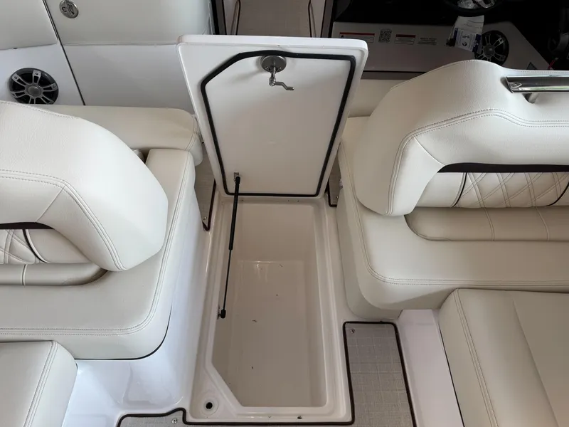 Slide: The Image of 2025 Regal LS6 boat interior with open storage compartment and white seating. - 9