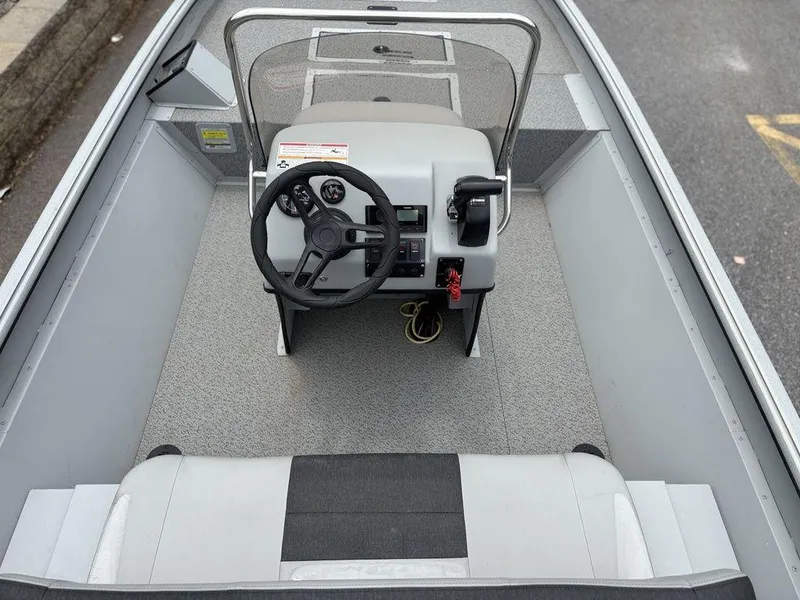 Slide: The Image of 2025 SeaArk Shadow 18 Center Console boat interior with steering wheel and seating. - 3