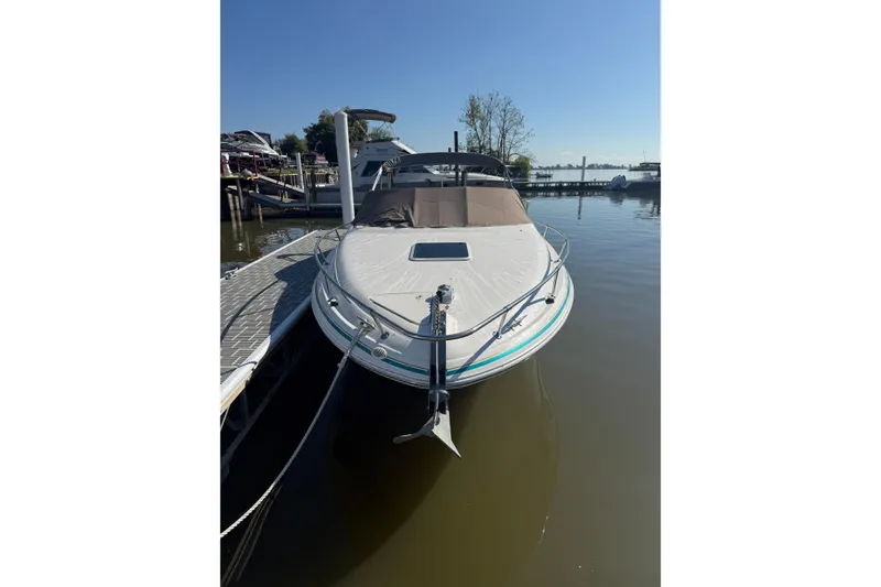 Slide: The Image of 1998 Sea Ray 280 Sun Sport boat docked at marina under clear blue sky. - 10