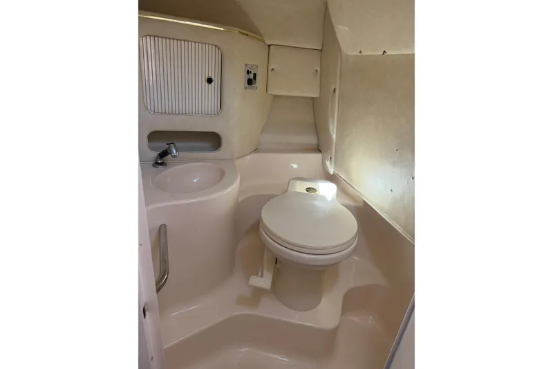 Slide: The Image of 1998 Sea Ray 280 Sun Sport boat bathroom with sink and toilet. - 11