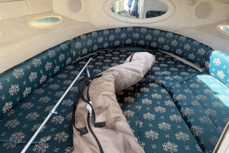 Slide: The Image of Interior cabin of 1998 Sea Ray 280 Sun Sport with patterned upholstery and gear. - 13