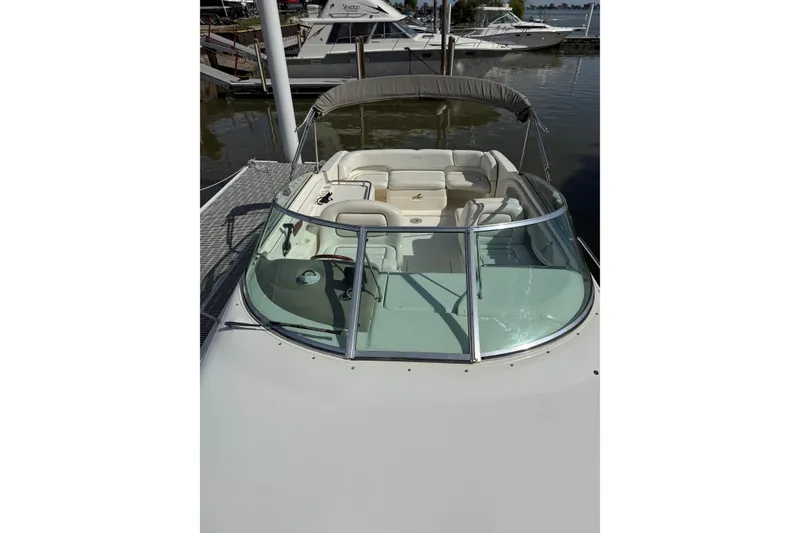 Slide: The Image of 1998 Sea Ray 280 Sun Sport boat docked, featuring spacious seating and sleek design. - 16