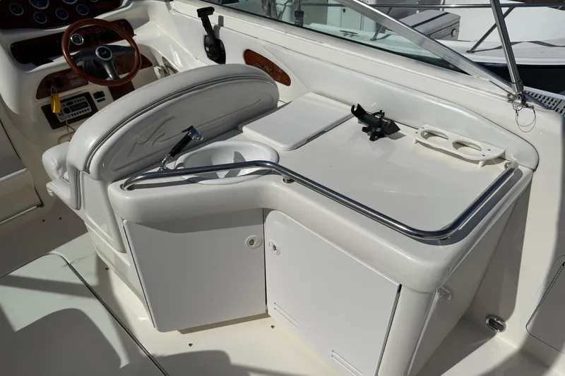 Slide: The Image of 1998 Sea Ray 280 Sun Sport boat interior with helm, seating, and storage compartments. - 17