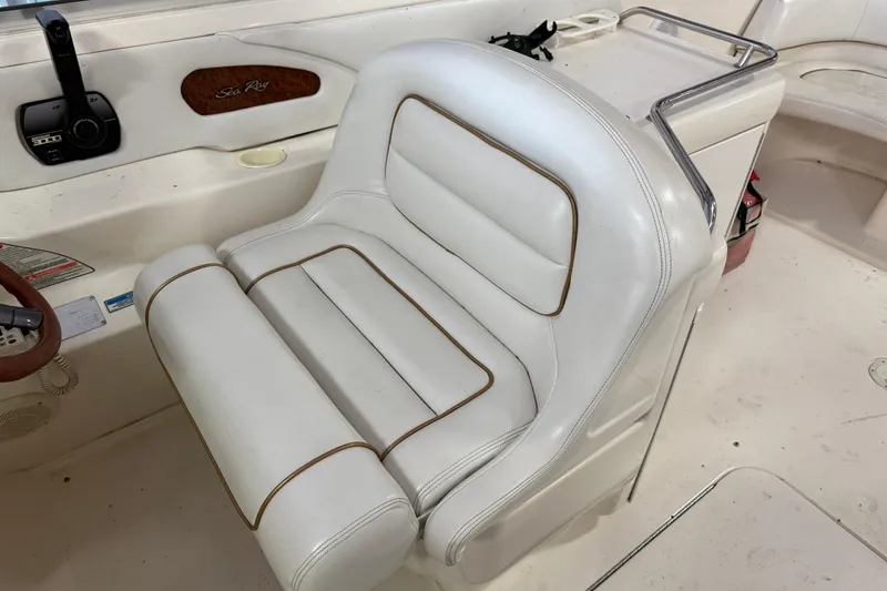 Slide: The Image of 1998 Sea Ray 280 Sun Sport boat interior with white leather seating and control panel. - 20