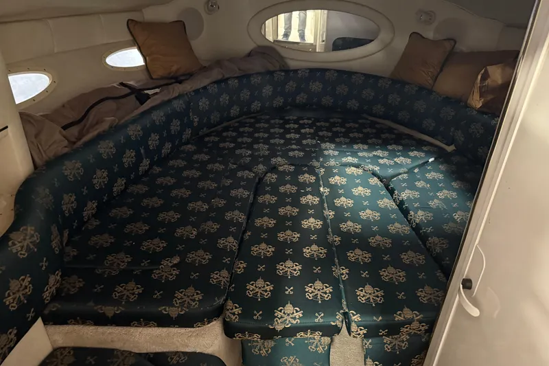 Slide: The Image of Interior cabin of 1998 Sea Ray 280 Sun Sport with patterned seating and pillows. - 9