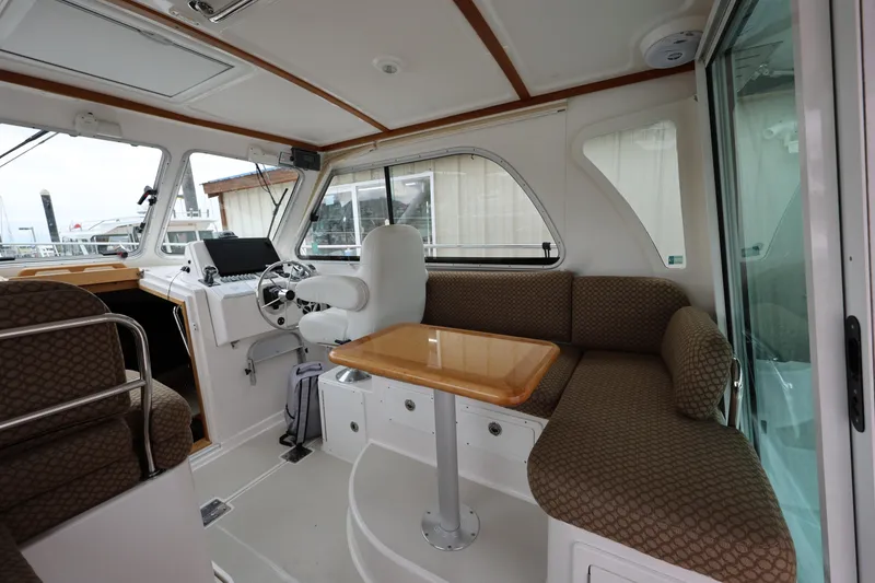 Slide: The Image of Interior of 2011 Back Cove 30 boat with helm, seating, and table. - 13