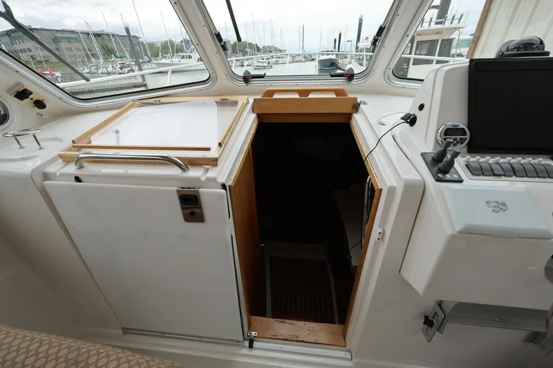 Slide: The Image of 2011 Back Cove 30 boat interior with helm station and cabin entrance. - 21