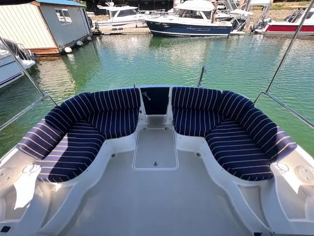 Slide: The Image of 2011 Back Cove 30 boat with striped seating in a marina setting. - 33