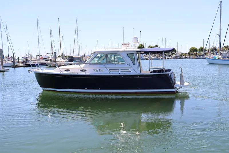 Slide: The Image of 2011 Back Cove 30 boat docked in marina, calm waters, clear sky. - 4