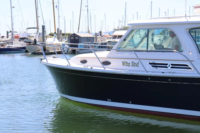 Slide: The Image of 2011 Back Cove 30 boat named "Witz End" docked in a marina. - 7