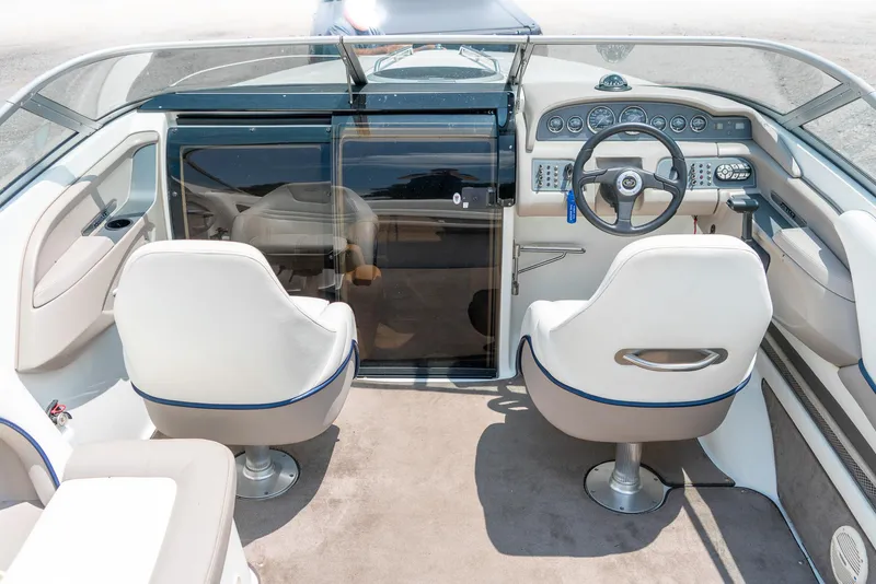 Slide: The Image of 2001 Cobalt 227 Cuddy boat interior with steering wheel and seating. - 14