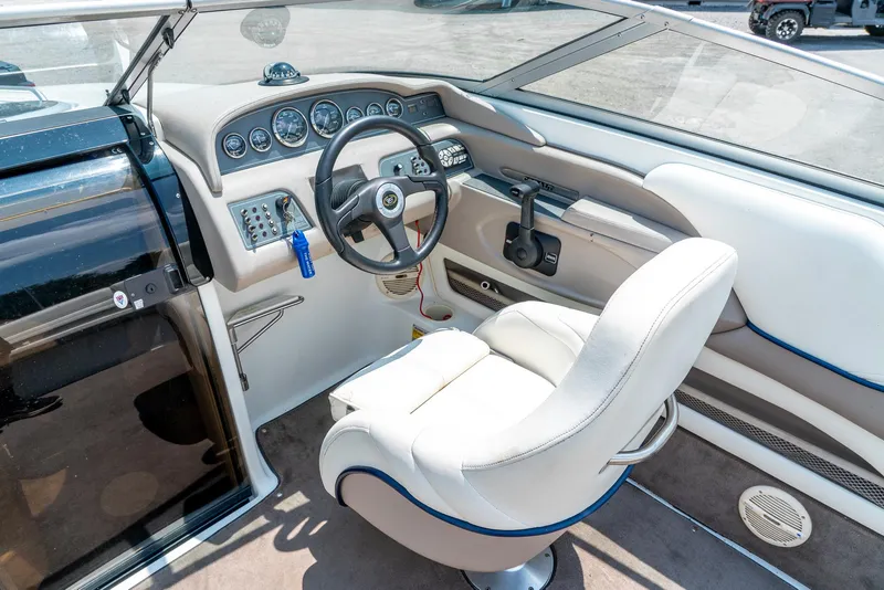 Slide: The Image of 2001 Cobalt 227 Cuddy boat interior with steering wheel and dashboard controls. - 15
