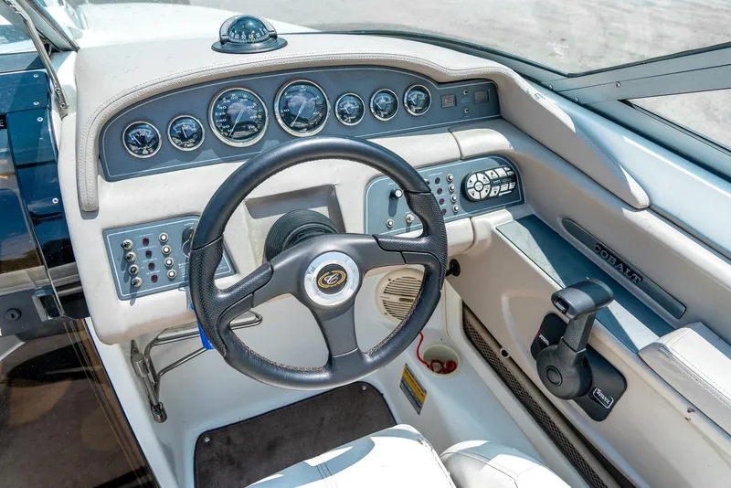 Slide: The Image of Cockpit of 2001 Cobalt 227 Cuddy boat with steering wheel and instrument panel. - 16