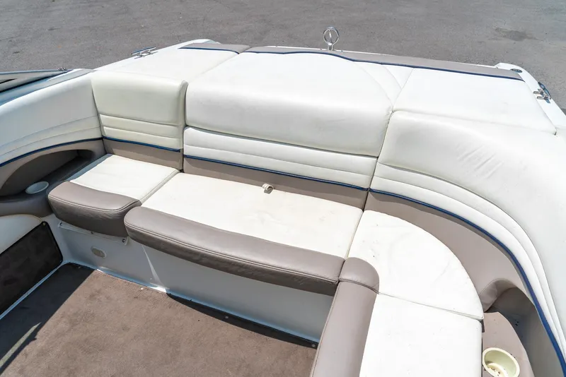 Slide: The Image of 2001 Cobalt 227 Cuddy boat interior with white and beige seating. - 22