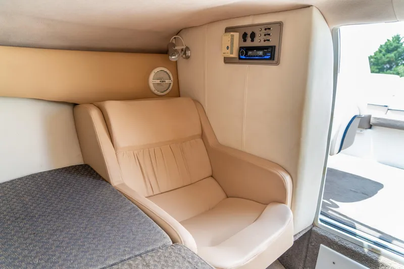 Slide: The Image of Interior of 2001 Cobalt 227 Cuddy boat with beige seating and control panel. - 24