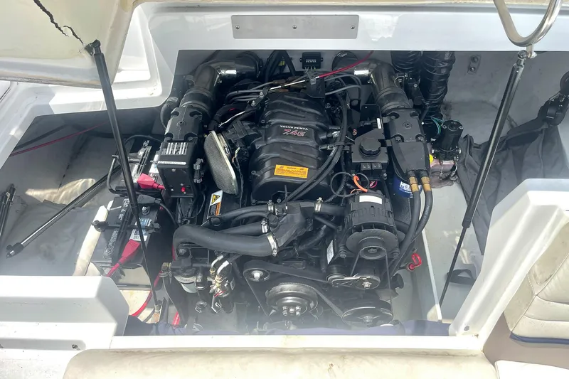Slide: The Image of Engine compartment of a 2001 Cobalt 227 Cuddy boat, showcasing detailed mechanical components. - 26