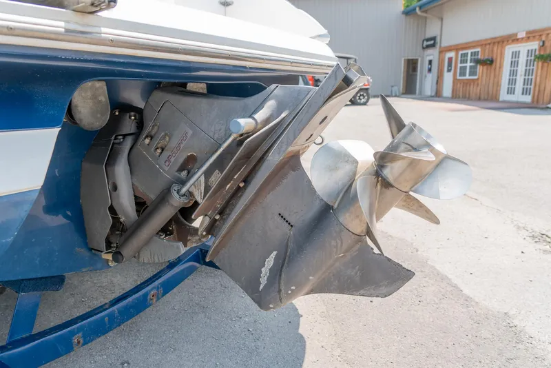Slide: The Image of 2001 Cobalt 227 Cuddy boat propeller and stern drive in a marina setting. - 27