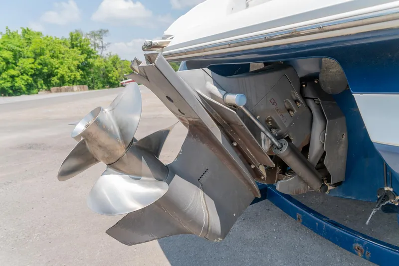 Slide: The Image of 2001 Cobalt 227 Cuddy boat propeller and stern drive in a parking area. - 28