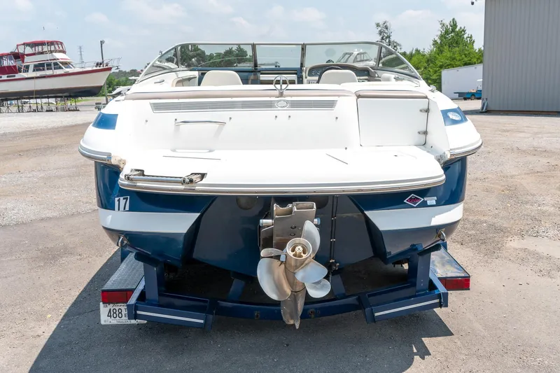 Slide: The Image of 2001 Cobalt 227 Cuddy boat on trailer, rear view, showcasing propeller and sleek design. - 7