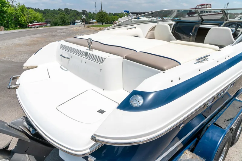 Slide: The Image of 2001 Cobalt 227 Cuddy boat on trailer, featuring sleek white and blue design. - 9