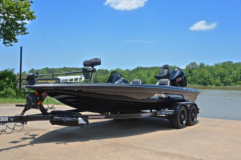 Slide: The Image of 2022 Phoenix 920 Elite boat on trailer by a lake under clear blue sky. - 11