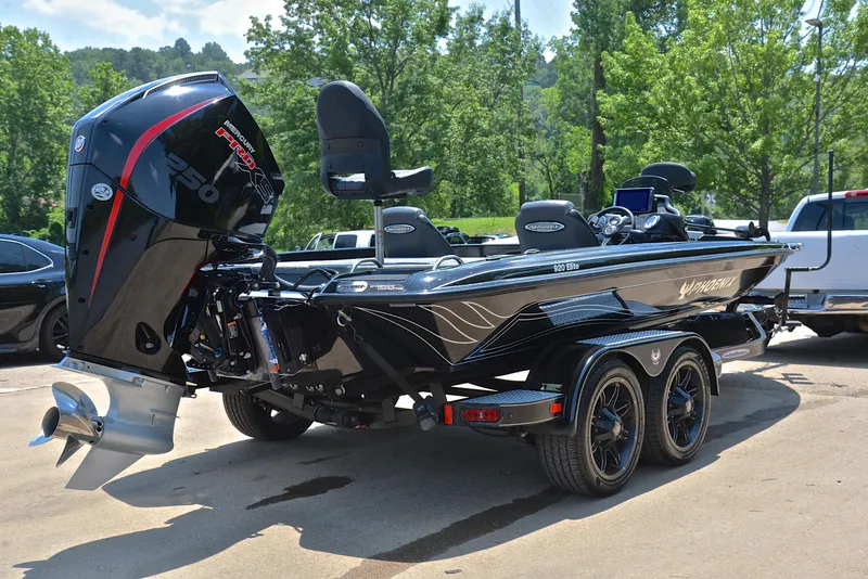 Slide: The Image of 2022 Phoenix 920 Elite boat with powerful engine, parked outdoors on a sunny day. - 15