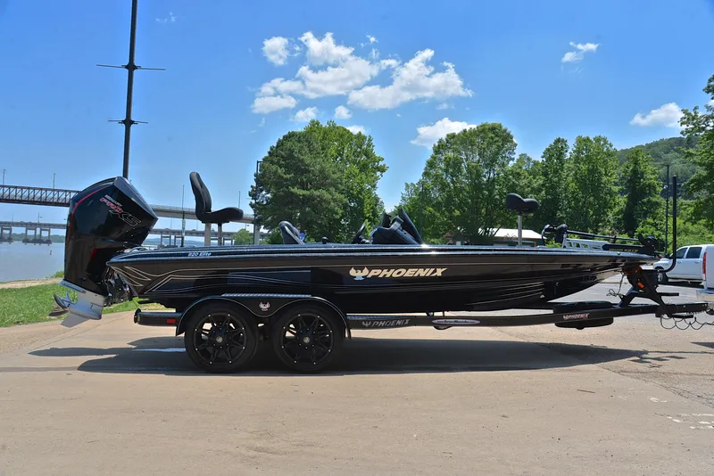 Slide: The Image of 2022 Phoenix 920 Elite boat on trailer, parked outdoors under blue sky. - 16