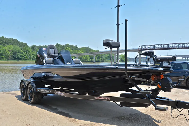Slide: The Image of 2022 Phoenix 920 Elite boat on trailer by a river, ready for launch. - 17