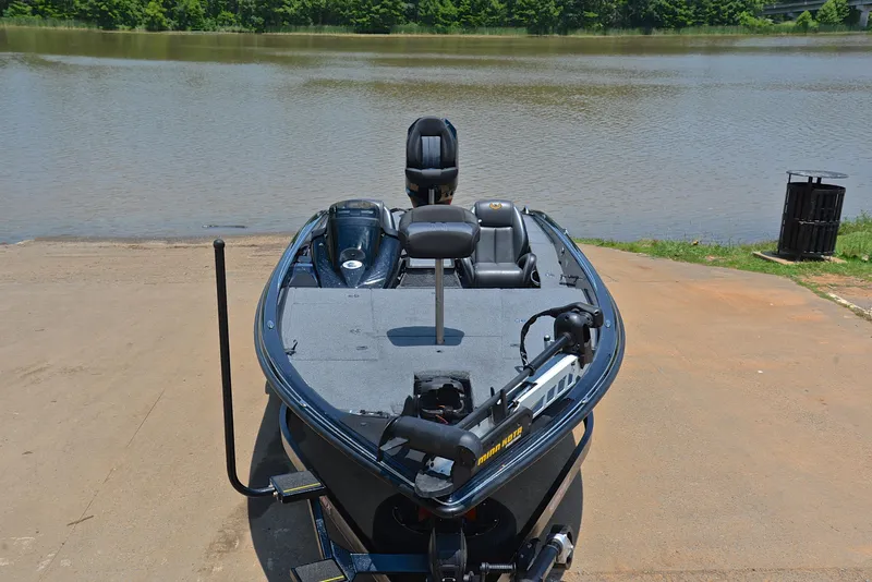 Slide: The Image of 2022 Phoenix 920 Elite boat at a lakeside dock, ready for fishing. - 18