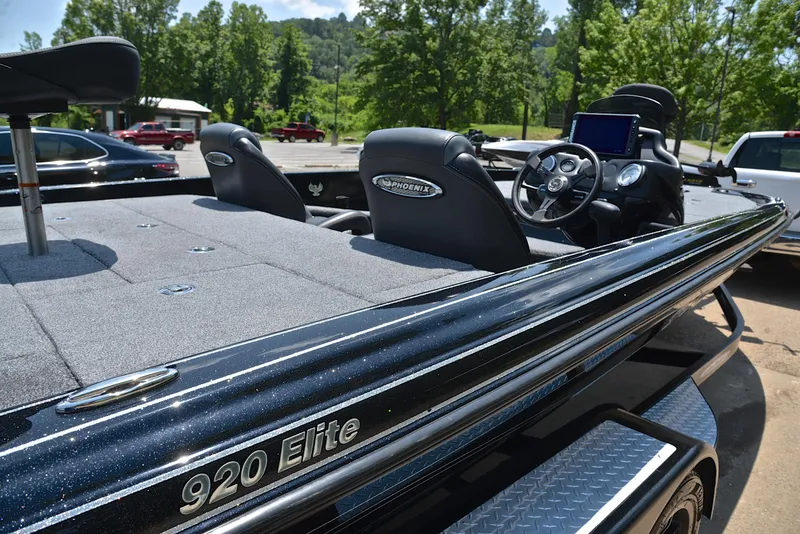 Slide: The Image of 2022 Phoenix 920 Elite boat with sleek design, parked outdoors. - 20